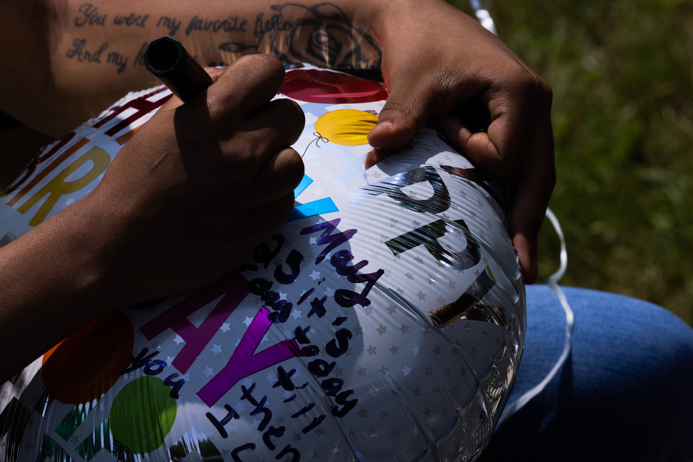 A person writes on a balloon.